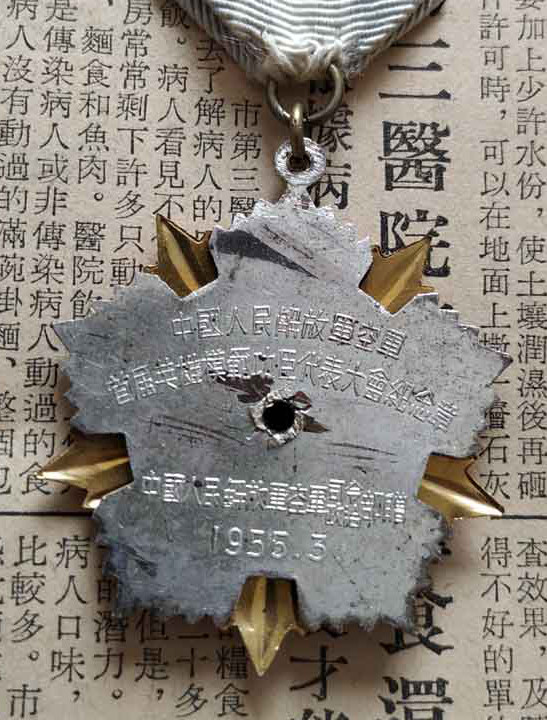 1955年3月颁发的首届空军英雄模范功臣代表大会纪念章 此章为配发品 带纪念章证书的罕见 同时拥有第二天的报纸报道 更是少见的大全套